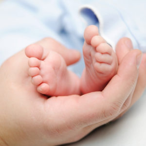 Picture of a doctor holding the baby's feet