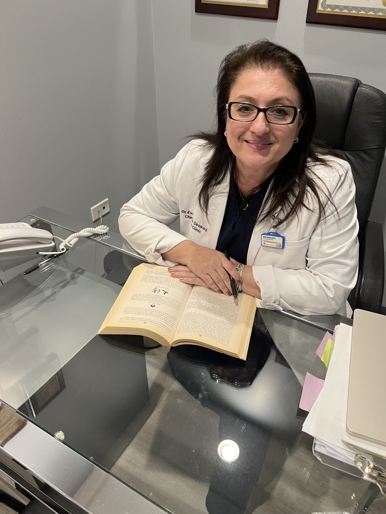 Dr. Angie Skokos, D.C. at her desk at Chiro Care Wellness Clinic in Westmont, IL