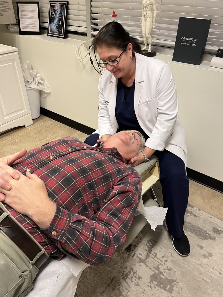 Dr. Angie Skokos treating a patient at Chiro Care Wellness Clinic