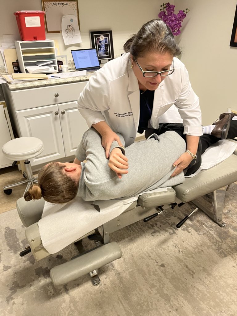 Dr. Angie Skokos assessing a patient&rsquo;s hip and leg