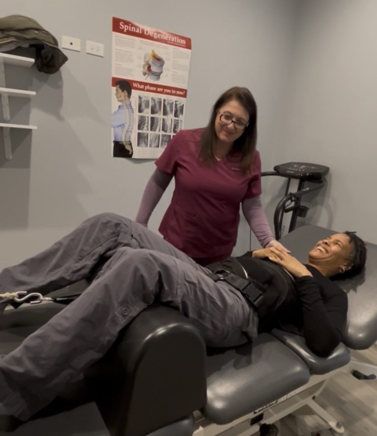 Dr. Angie Skokos with a patient on the spinal traction table