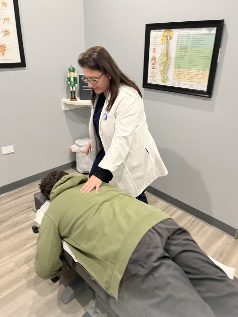 Dr. Angie Skokos adjusting a patient at her Westmont clinic