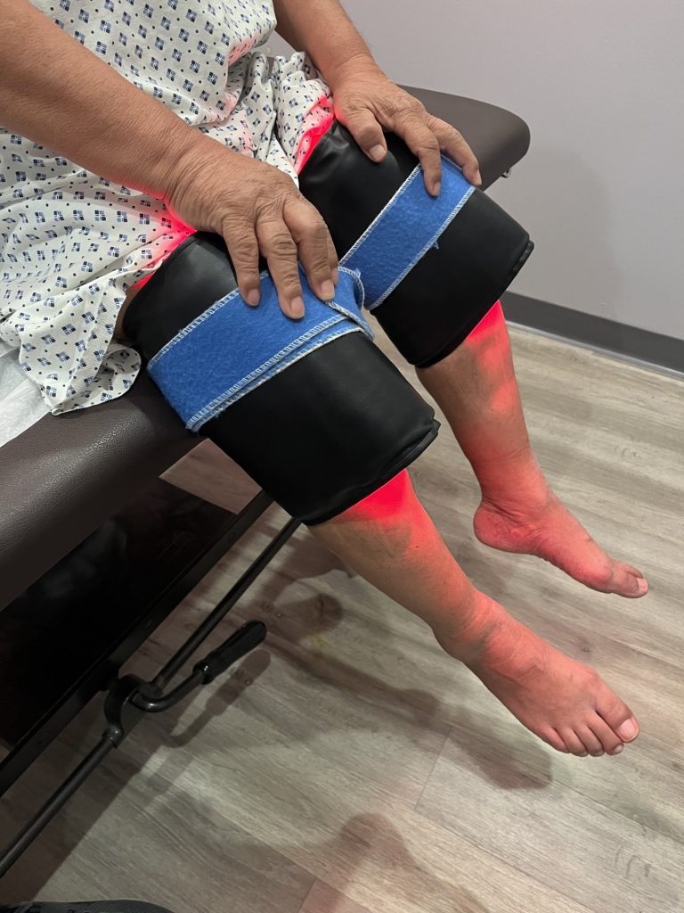 Red light therapy pad applied to a patient&rsquo;s leg at Chiro Care Wellness Clinic