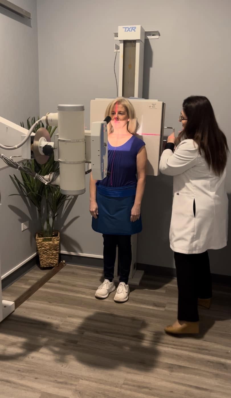 Dr. Angie Skokos positioning a patient at the on-site X-ray unit in her Westmont clinic